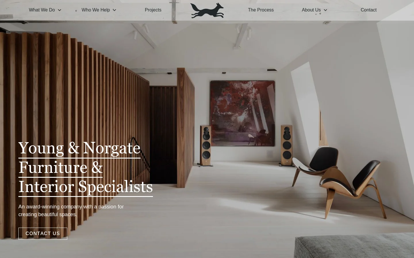 The desktop homepage features a large hero image of a minimalist, modern interior with wood paneling and designer chairs. The headline 'Young & Norgate Furniture & Interior Specialists' is prominently displayed on the left with a 'CONTACT US' button below. A clean navigation bar at the top includes links for What We Do, Who We Help, Projects, The Process, About Us, and Contact.