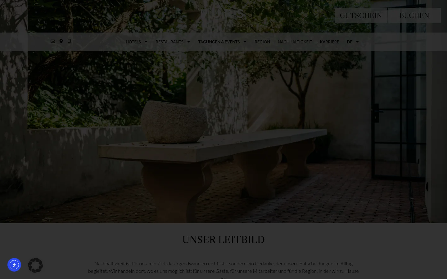 The desktop page features a large hero image of a stone bench and planter in a sunlit courtyard, overlaid with a navigation menu and 'GUTSCHEIN' and 'BUCHEN' buttons. Below the hero section, the 'UNSER LEITBILD' headline introduces text content about sustainability organized into sections like Environment, Social Responsibility, and Region. The design uses a sophisticated palette of earthy tones, dark greens, and cream.