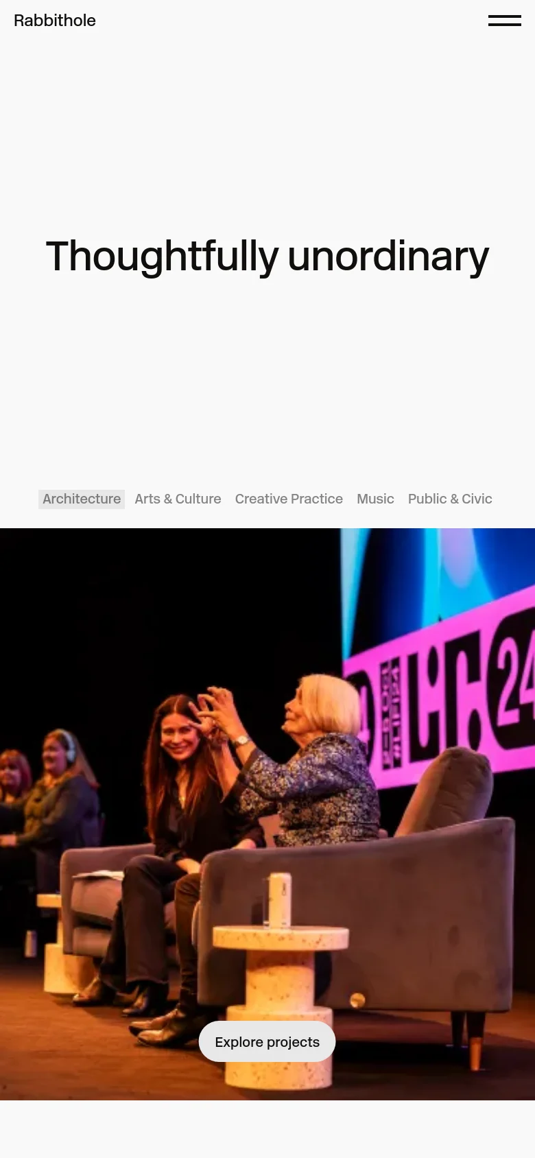 The mobile version maintains the minimalist white aesthetic and centered 'Thoughtfully unordinary' headline. The industry navigation links are stacked or wrapped more tightly to fit the narrow screen. The hero image remains at the bottom but appears more vertically cropped compared to the desktop view.