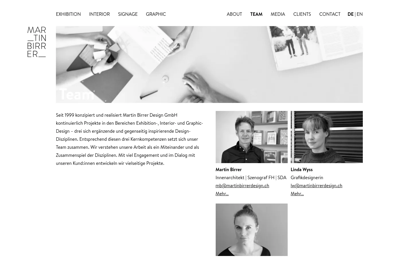 The desktop page features a minimalist white background with a large black and white hero image of hands working on design layouts. Below the hero image, a text block describes the team's multidisciplinary approach, positioned next to a grid of black and white portrait photos of team members including Martin Birrer and Linda Wyss.