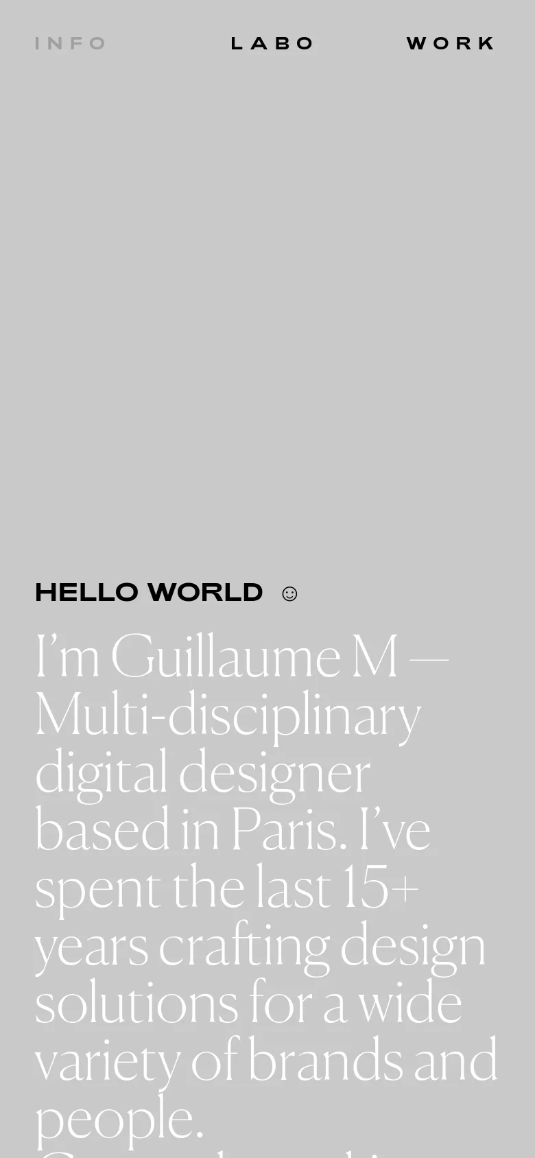 The mobile version maintains the minimalist aesthetic and light gray background but scales the large serif typography to fit the narrower screen. The navigation links 'INFO', 'LABO', and 'WORK' are positioned at the top, and the hero text 'HELLO WORLD' and the introductory bio are stacked vertically for readability.