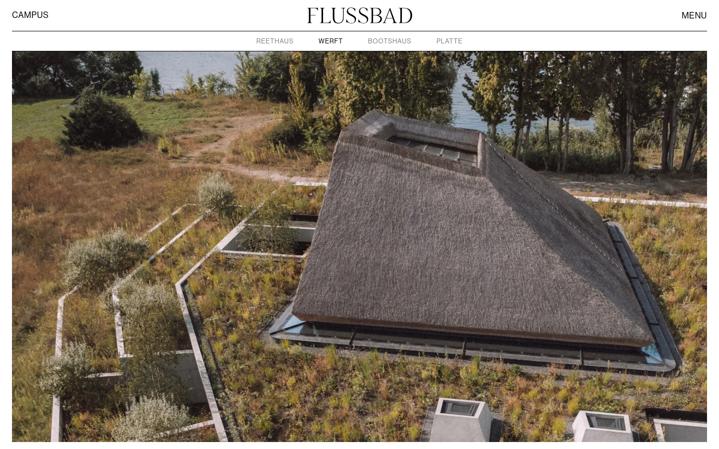 The desktop page features a minimalist white header with the 'FLUSSBAD' logo centered, a 'CAMPUS' label, and a 'MENU' button. Below, a sub-navigation menu lists 'REETHAUS', 'WERFT', 'BOOTSHAUS', and 'PLATTE'. A large hero image shows an aerial view of a modern building with a large thatched roof surrounded by greenery and water.