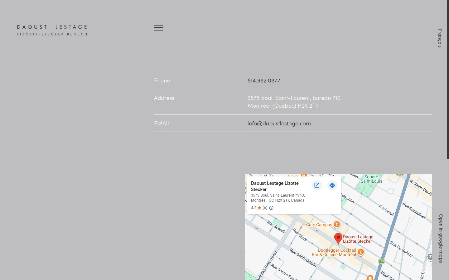 The desktop contact page features a minimalist design with a light gray background and white text. Contact details including phone, address, and email are listed vertically on the left, while a large embedded Google Map showing the office location occupies the bottom right corner. The company logo is positioned in the top left corner.