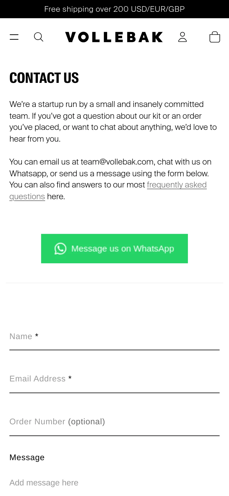 The mobile version uses a single-column layout with the 'CONTACT US' headline and text centered at the top. The green WhatsApp button and the contact form fields are stacked vertically to fit the narrow screen, maintaining the clean white and black aesthetic.