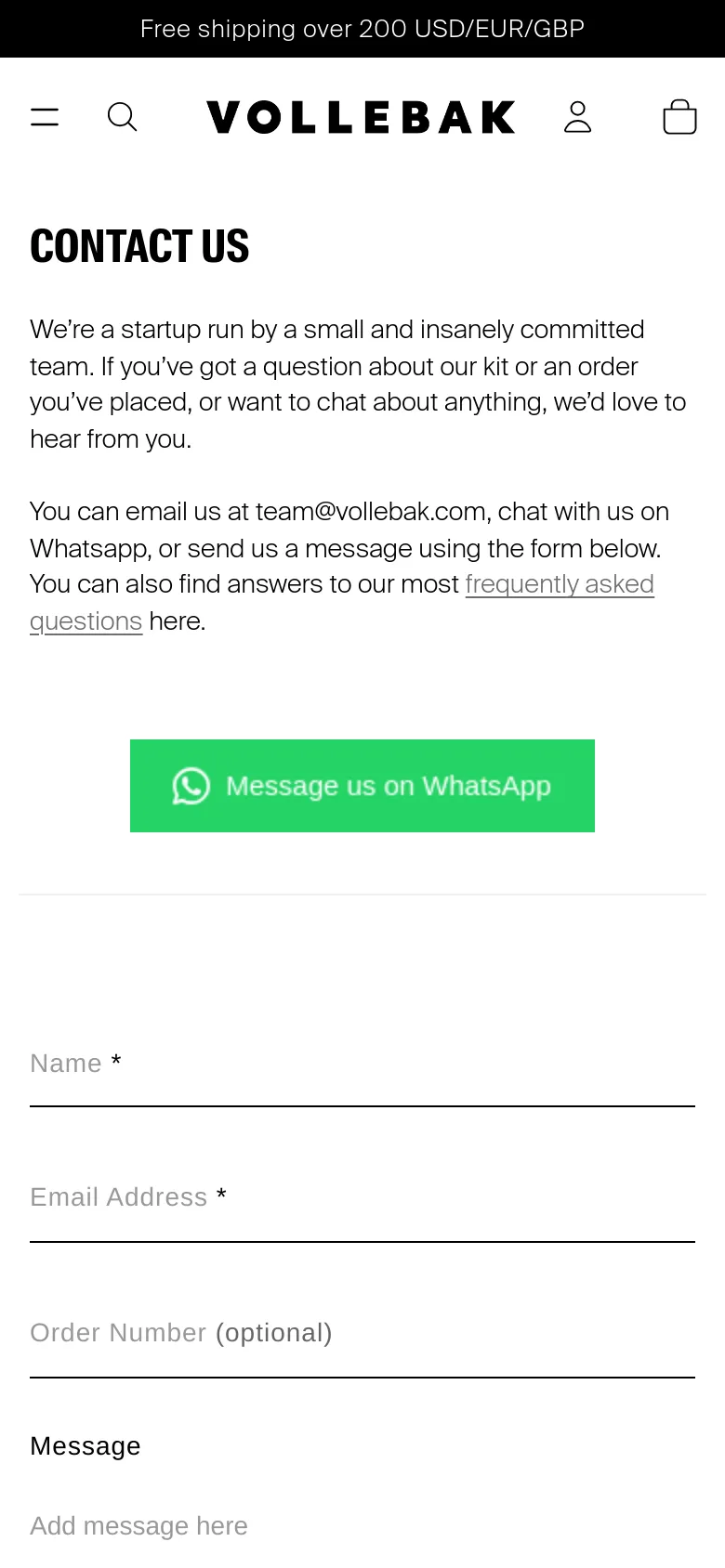 The mobile version uses a single-column layout with the 'CONTACT US' headline and text centered at the top. The green WhatsApp button and the contact form fields are stacked vertically to fit the narrow screen, maintaining the clean white and black aesthetic.