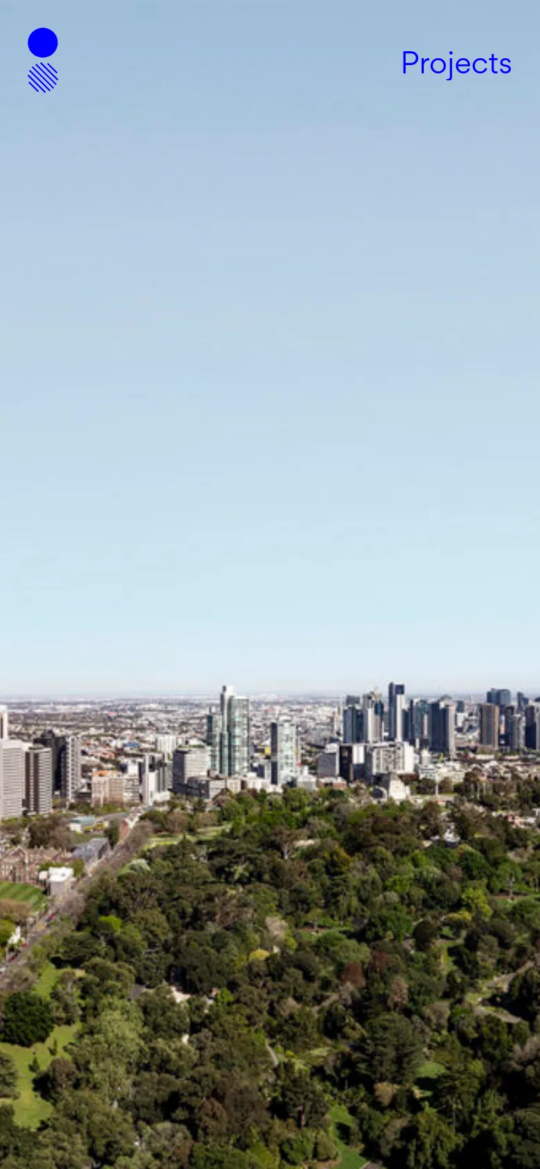 The mobile version maintains the minimalist aesthetic, focusing on the expansive city skyline and greenery hero image. The layout is vertically oriented, with the blue logo positioned in the top left and the 'Projects' link in the top right, maximizing the visual impact of the landscape on a smaller screen.