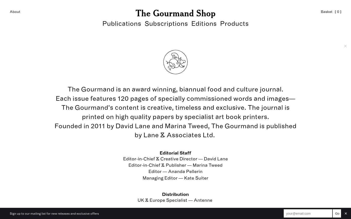 The About page for The Gourmand Shop features a minimalist white layout with black serif typography. A central line-art illustration of a fish is positioned above a large text block describing the biannual food and culture journal. The navigation menu includes links for Publications, Subscriptions, Editions, and Products, with a shopping basket indicator in the top right.