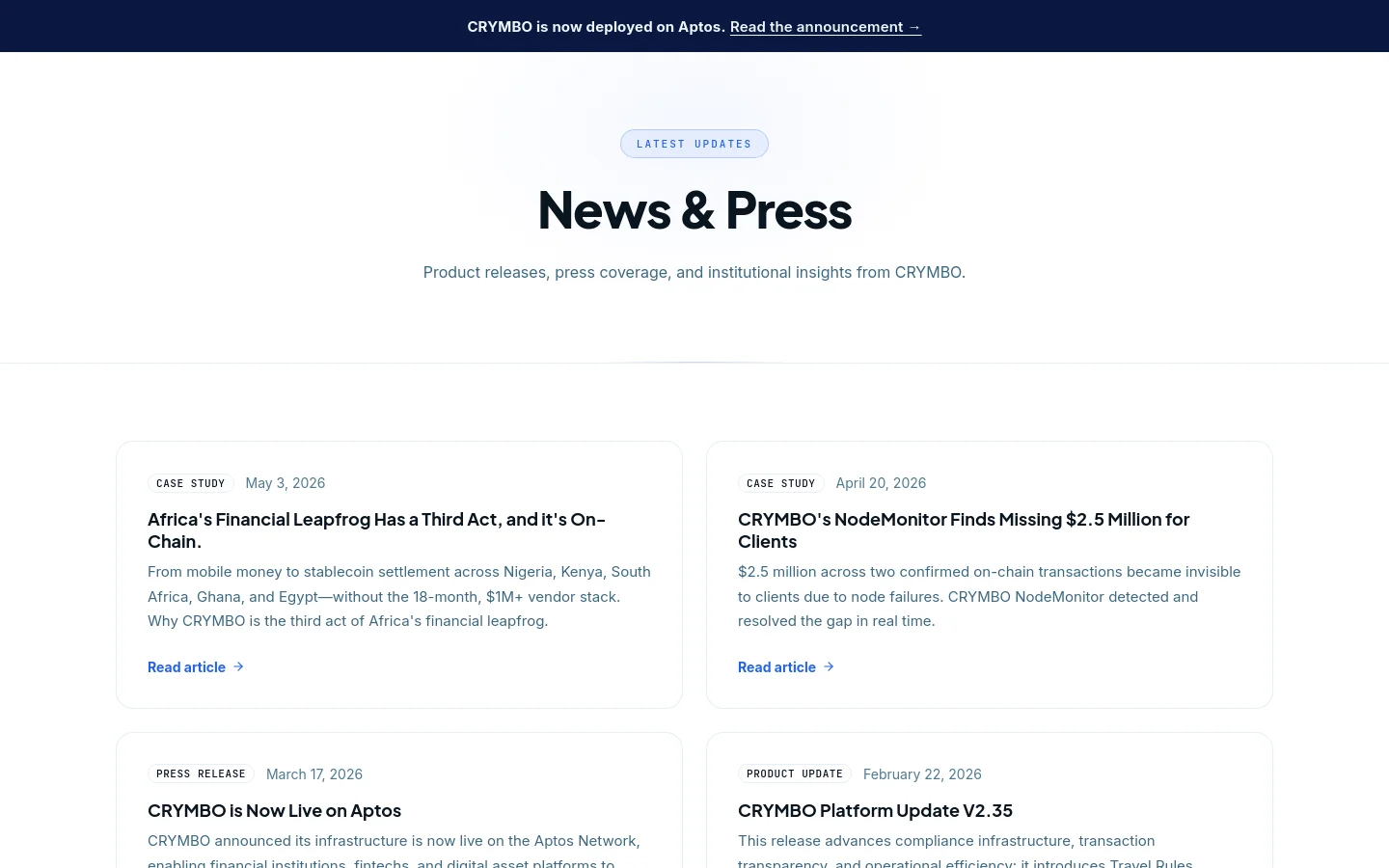 The News & Press desktop page features a clean, minimalist design with a white background and dark blue accents. A large centered headline 'News & Press' is followed by a subheadline, with a dark blue announcement banner at the top. Below, news items are organized in a grid of white cards containing category tags, dates, bold headlines, brief descriptions, and blue 'Read article' links.