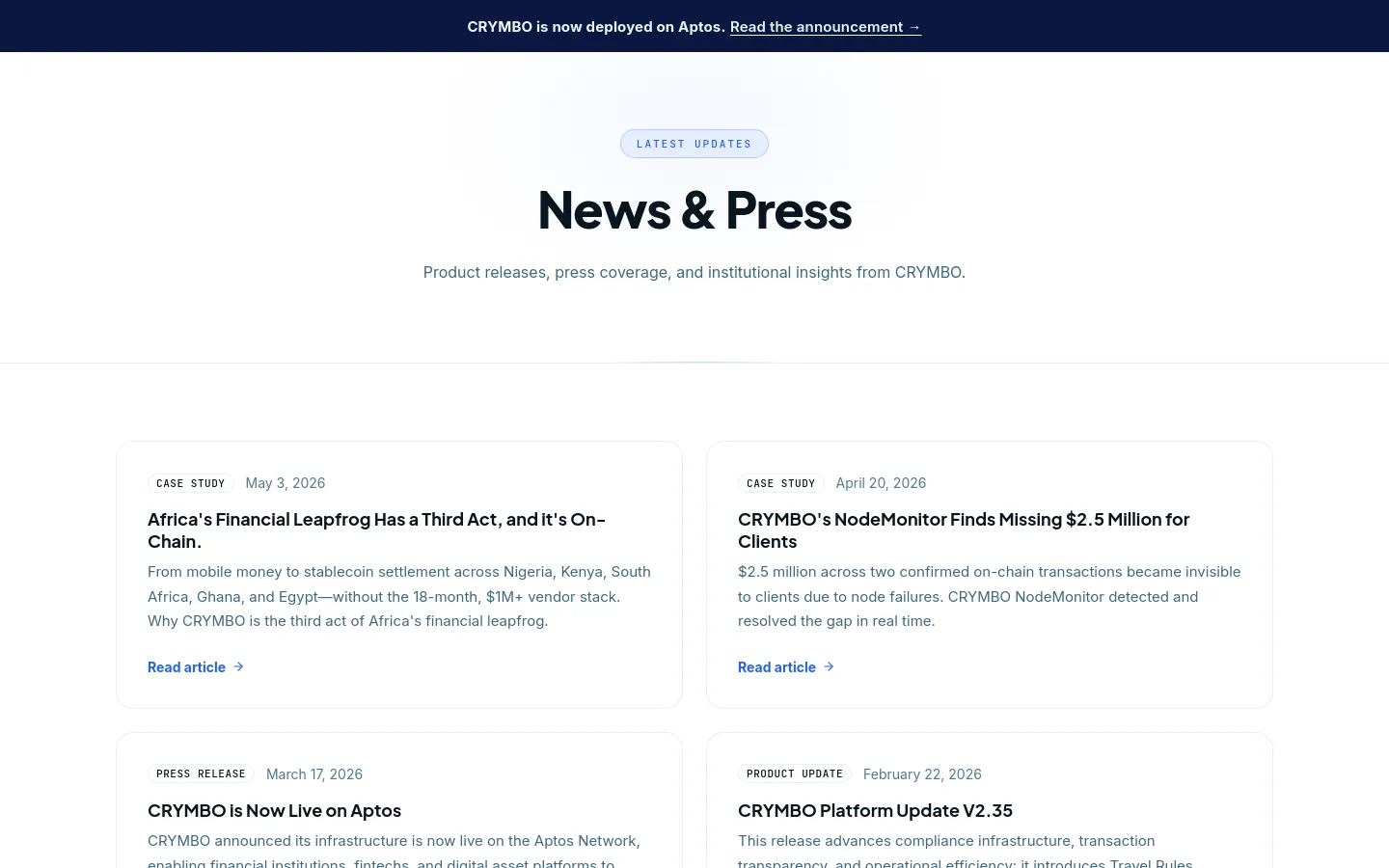 The News & Press desktop page features a clean, minimalist design with a white background and dark blue accents. A large centered headline 'News & Press' is followed by a subheadline, with a dark blue announcement banner at the top. Below, news items are organized in a grid of white cards containing category tags, dates, bold headlines, brief descriptions, and blue 'Read article' links.