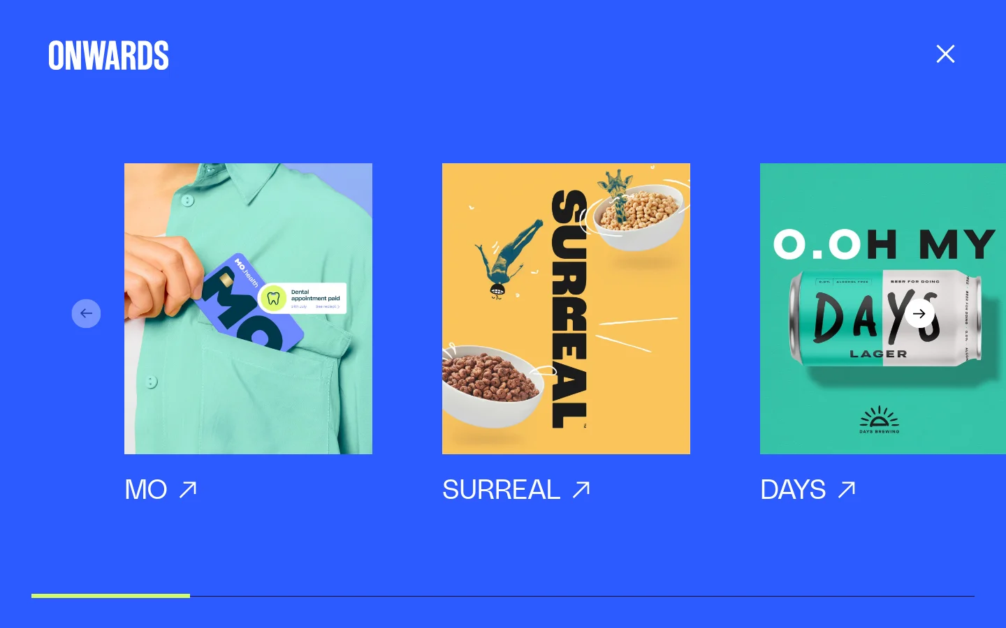 The Work archive page features a bright blue background with a horizontal grid of large project tiles. Each tile displays a colorful image representing a case study, such as 'MO', 'SURREAL', and 'DAYS', with the project name and an external link icon below it. Navigation arrows are positioned on the left and right sides of the central content area.