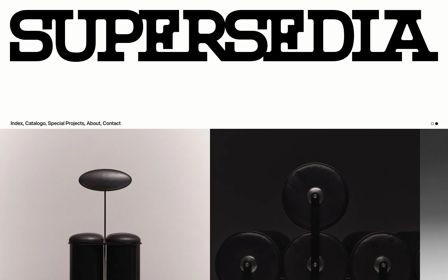 The desktop homepage features a large, bold black 'SUPERSEDIA' logo at the top, followed by a minimalist navigation menu with links for Index, Catalogo, Special Projects, About, and Contact. Below the menu, a large hero image displays a sculptural black object against a neutral grey background, with pagination dots indicating a slider.