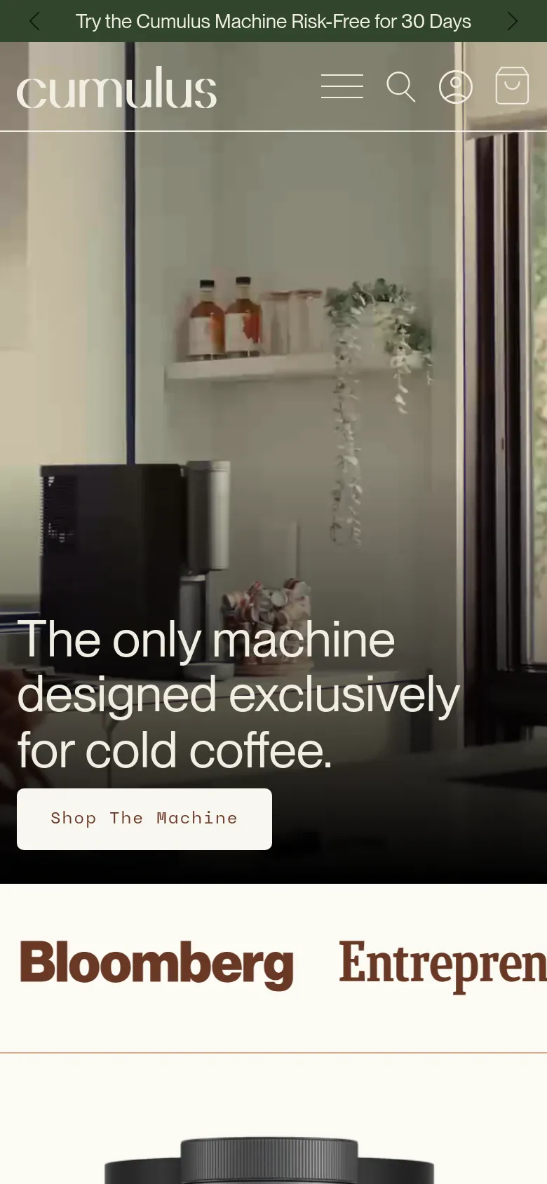 Mobile version of the homepage with a vertically stacked layout. The hero image shows the kitchen setting with the primary headline and 'Shop The Machine' button centered over the image. A hamburger menu, search icon, and user profile icon are visible in the header, followed by large media logos like Bloomberg below the hero section.