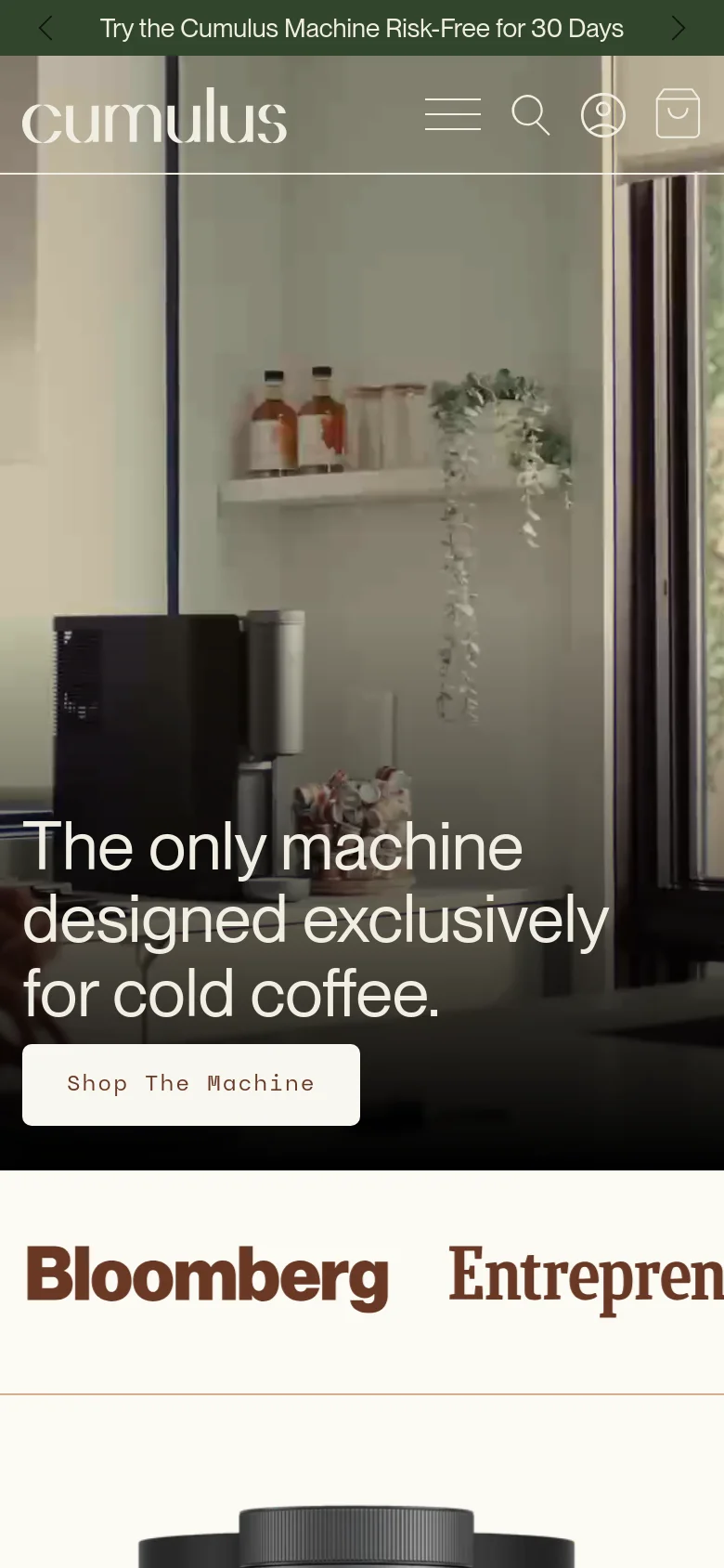Mobile version of the homepage with a vertically stacked layout. The hero image shows the kitchen setting with the primary headline and 'Shop The Machine' button centered over the image. A hamburger menu, search icon, and user profile icon are visible in the header, followed by large media logos like Bloomberg below the hero section.