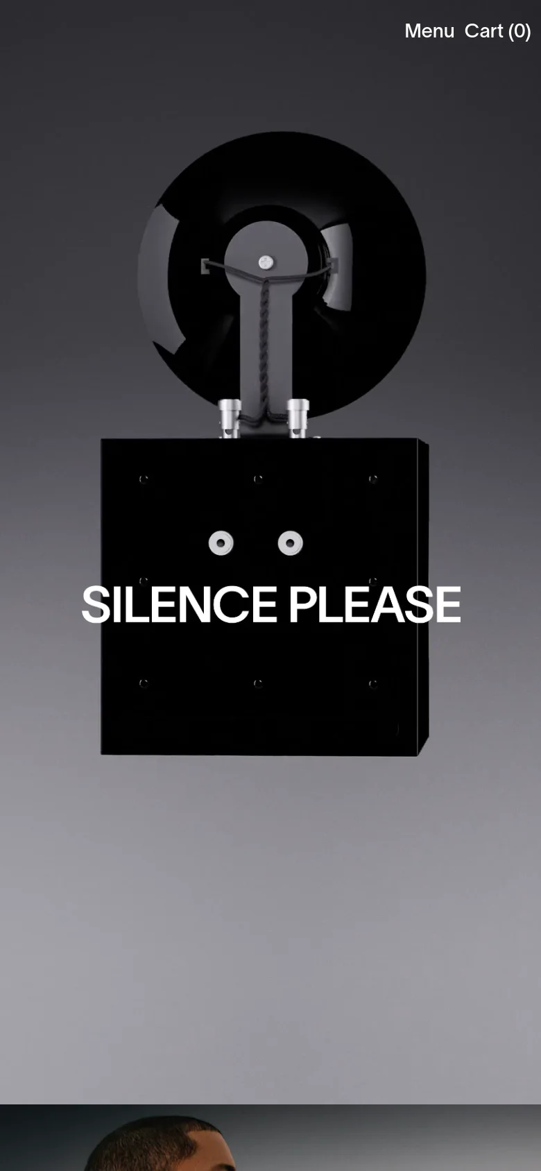 The mobile version displays a similar minimalist design with the black sculptural speaker and white 'SILENCE PLEASE' text centered. The layout is simplified for a smaller screen, replacing the top navigation bar with a 'Menu' link and a 'Cart (0)' indicator at the top right.