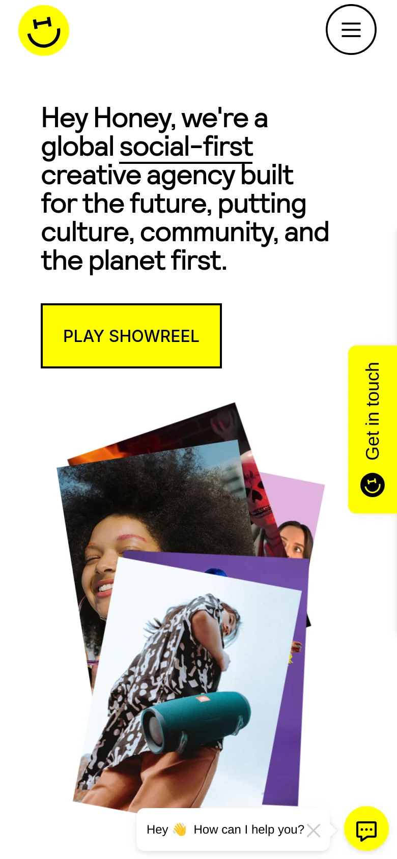 The mobile version stacks the content vertically, placing the large bold headline at the top followed by the yellow 'PLAY SHOWREEL' button. The overlapping photo collage is positioned below the button, and a floating chat widget appears at the bottom right.