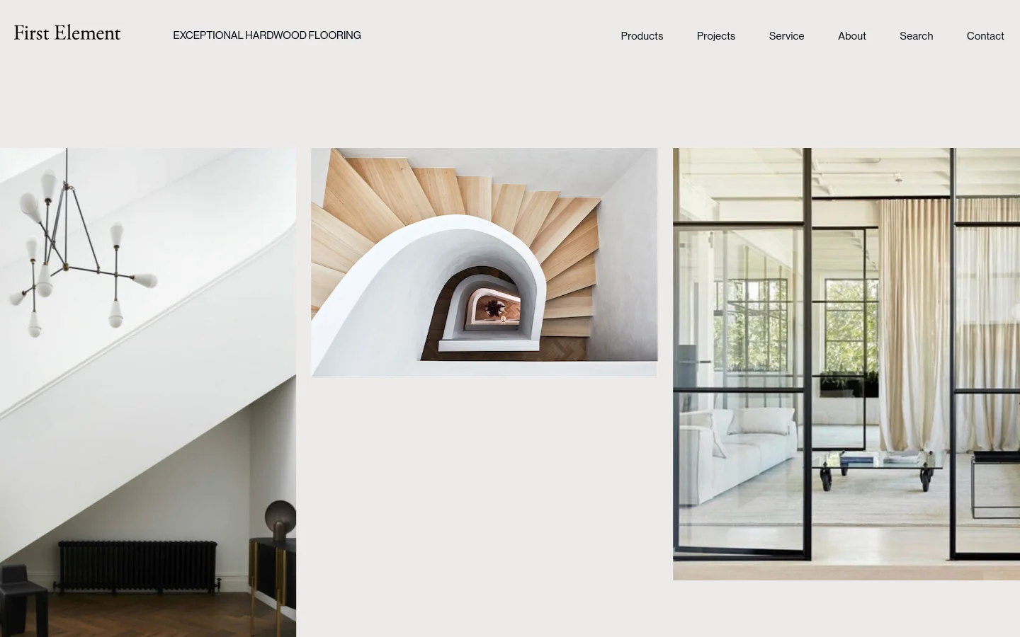 The desktop homepage for First Element features a minimalist design with a light beige background and a top navigation menu including Products, Projects, Service, About, Search, and Contact. The hero section displays a large, high-quality collage of three architectural interior images showcasing modern staircases, light-filled rooms, and hardwood flooring. The headline 'Exceptional Hardwood Flooring' is positioned prominently near the logo.
