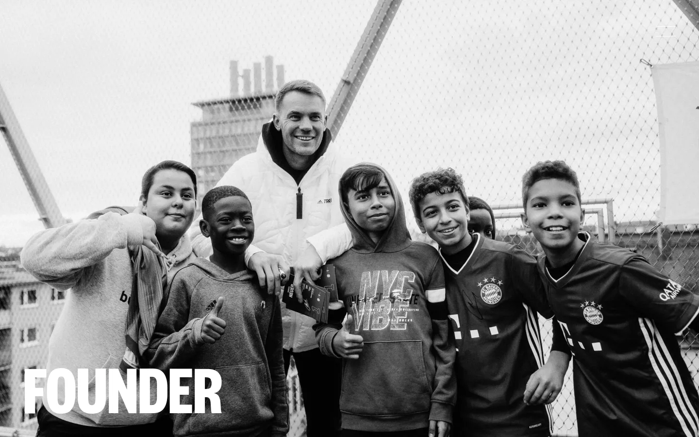 The desktop page features a large black and white hero image of Manuel Neuer smiling with a group of children, with the word 'FOUNDER' in large white capital letters in the bottom left. Below the image, the page layout includes text sections about the Kids Foundation, foundation logos, and detailed descriptions of their mission and projects on a clean white background.
