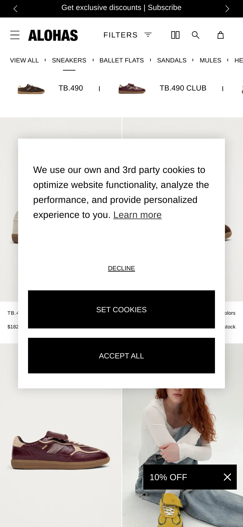 The mobile version presents a simplified vertical layout with a hamburger menu and a single-column product grid. The top navigation is condensed into a scrollable list of categories, and a large cookie consent pop-up overlays the center of the screen. A small '10% OFF' promotional banner is visible at the bottom of the viewport.