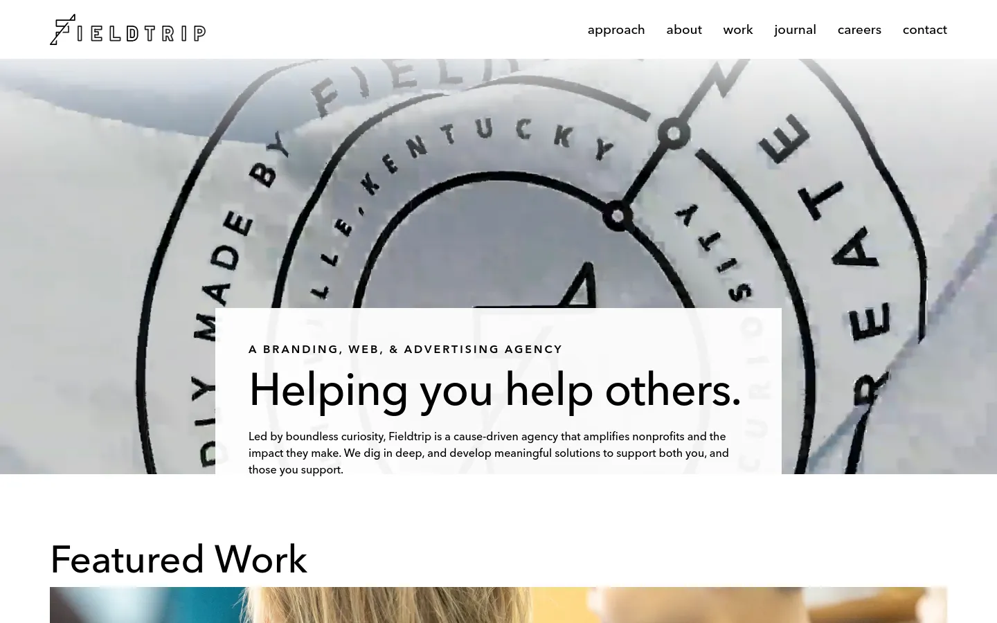 The desktop homepage features a minimalist design with a large hero image showing a close-up, stylized graphic of a circular emblem. Centered over the image is a white text box containing the headline 'Helping you help others.' and a brief description of the agency. A navigation menu at the top right includes links for approach, about, work, journal, careers, and contact.