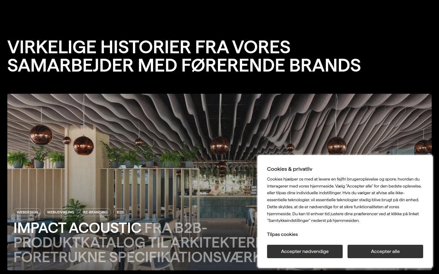 The desktop page features a dark theme with a large hero section displaying a high-quality architectural interior image and the headline 'VIRKELIGE HISTORIER FRA VORES SAMARBEJDER MED FØRENDE BRANDS'. Below, a grid of case studies shows large imagery, service tags like 'Webdesign' and 'Webudvikling', and brand names such as Impact Acoustic and Mos Mosh. A cookie consent pop-up is visible in the bottom right corner.