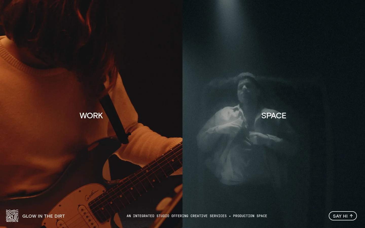 The desktop homepage features a split-screen layout with warm-toned imagery of a person playing a guitar on the left and cool-toned, moody imagery of a person in a spotlight on the right. Large white text overlays each side reading 'WORK' and 'SPACE', serving as primary navigation links. A footer contains the studio name, a brief description, and a 'SAY HI' call-to-action button.