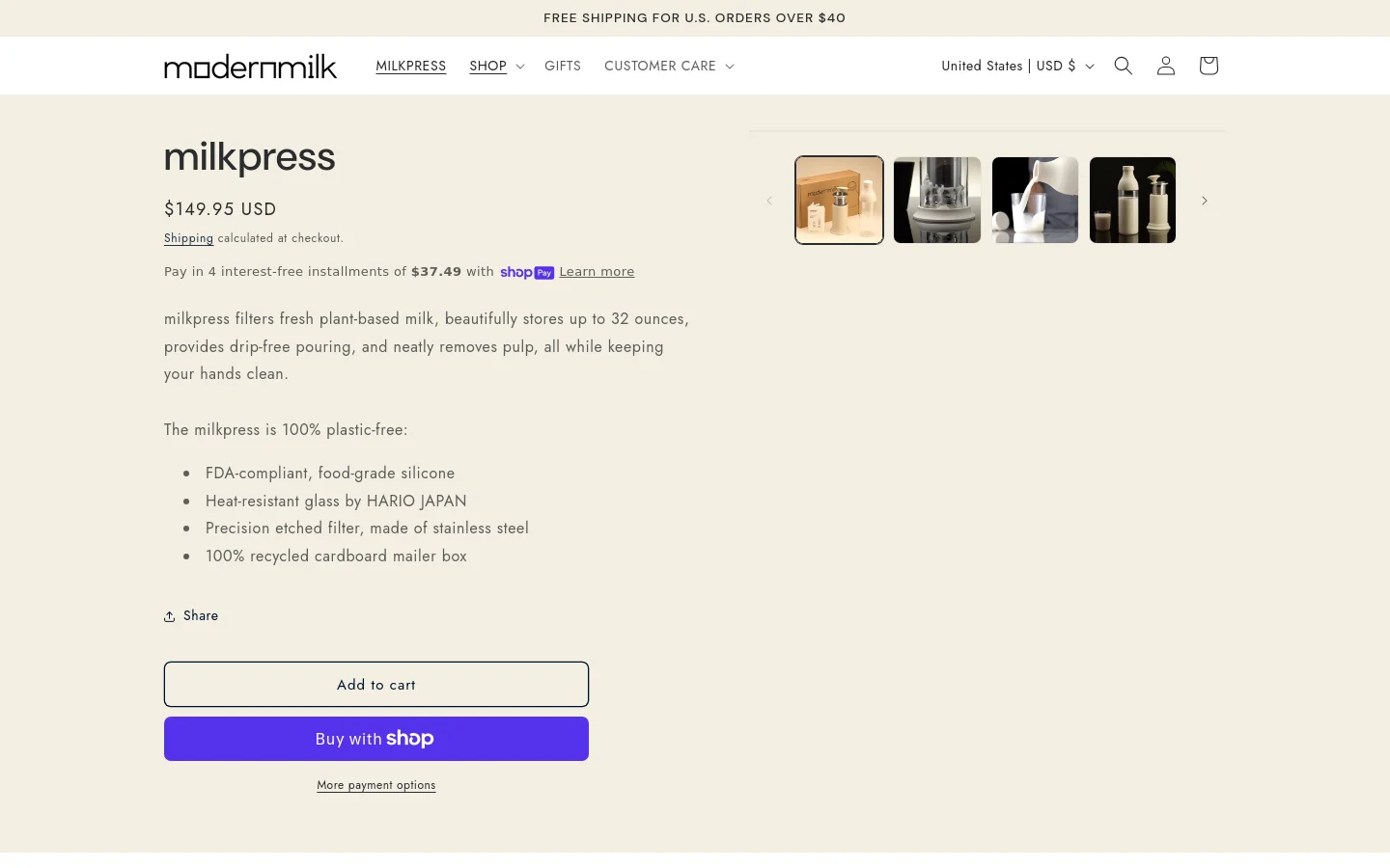 The desktop product page for milkpress features a minimalist design with a white background and black text. A large product image gallery is positioned on the right, showing various views of the glass and stainless steel milk press, while the left side contains the product title, price of $149.95 USD, descriptive text, and 'Add to cart' and 'Buy with Shop' buttons.