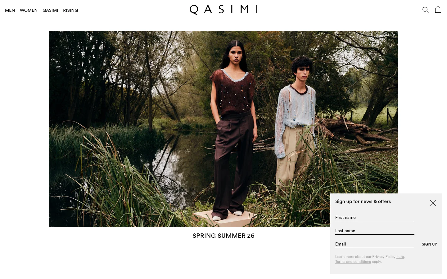 The desktop homepage features a minimalist layout with a large hero image of two models in nature by a river. Below the image, the headline 'SPRING SUMMER 26' is centered, and a 'Sign up for news & offers' pop-up overlay is visible on the right side. The navigation bar at the top includes links for Men, Women, Qasimi, and Rising, alongside a search icon and shopping bag.
