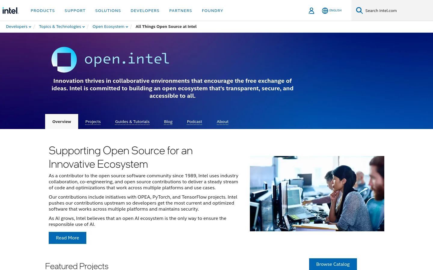 The desktop homepage features a deep blue hero section with the 'open.intel' logo and a mission statement about collaborative innovation. Below the hero, a white content area contains a section titled 'Supporting Open Source for an Innovative Ecosystem' with descriptive text next to a photo of people working in an office, followed by a 'Featured Projects' section.