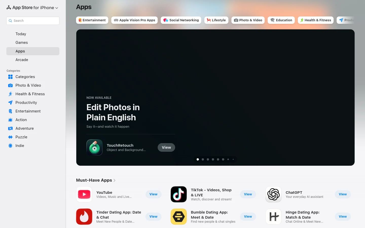 The desktop page for the App Store features a dark sidebar on the left with navigation links and categories. The main content area displays a large hero carousel showcasing featured apps like TouchRetouch against a dark background, followed by a 'Must-Have Apps' section with a grid of app icons, titles, and blue 'View' buttons.