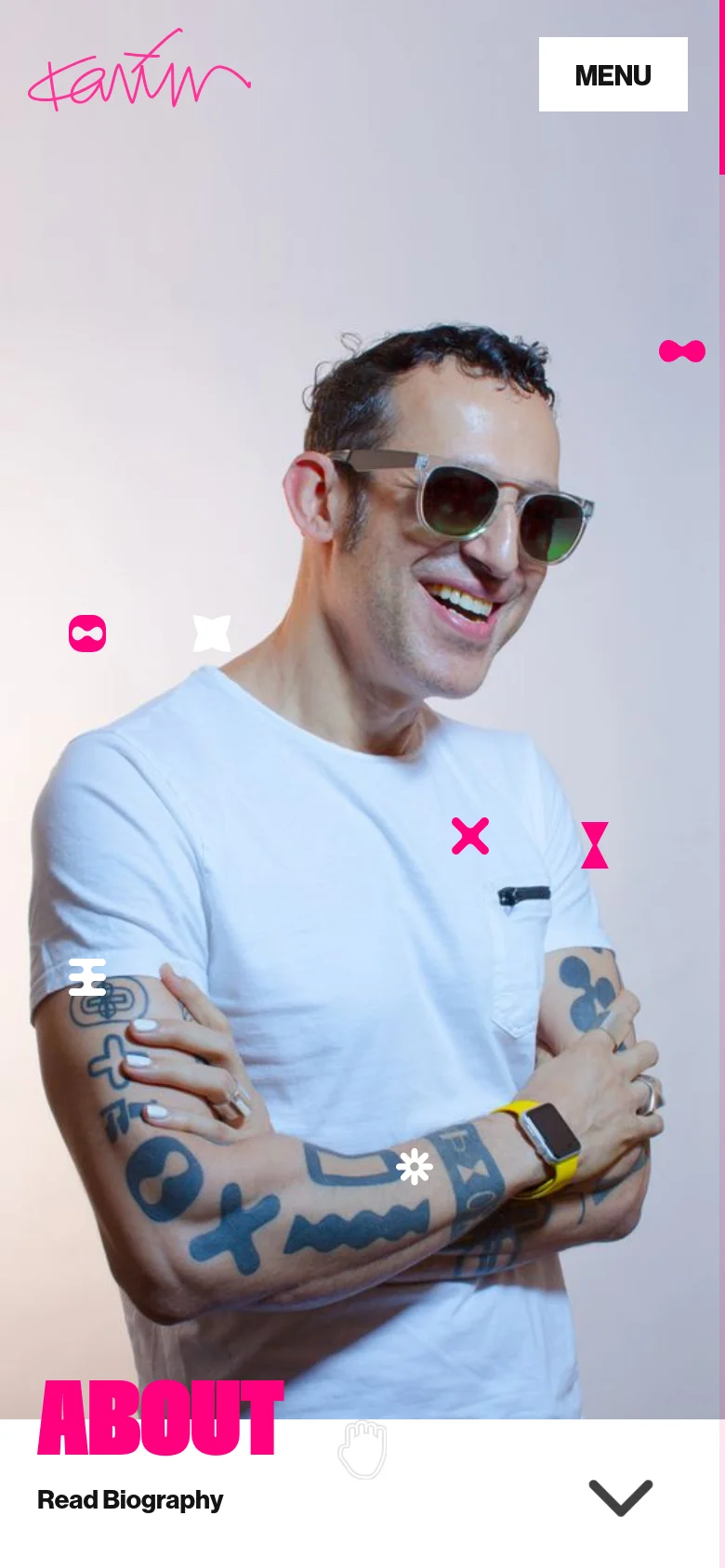 The mobile version displays a vertically oriented hero image of Karim Rashid, with the pink 'ABOUT' headline positioned at the bottom left. The layout is condensed, placing the 'MENU' button at the top right and the 'Read Biography' link with a downward arrow at the bottom.