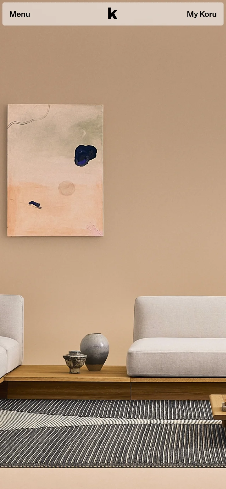 The mobile version presents a simplified layout with a prominent 'Menu' button on the left and 'My Koru' on the right of a centered logo. The hero section features a large, vertical-oriented image of the minimalist living room decor, emphasizing the abstract painting and furniture. The navigation is condensed into a hamburger-style menu to maximize screen space for visual content.