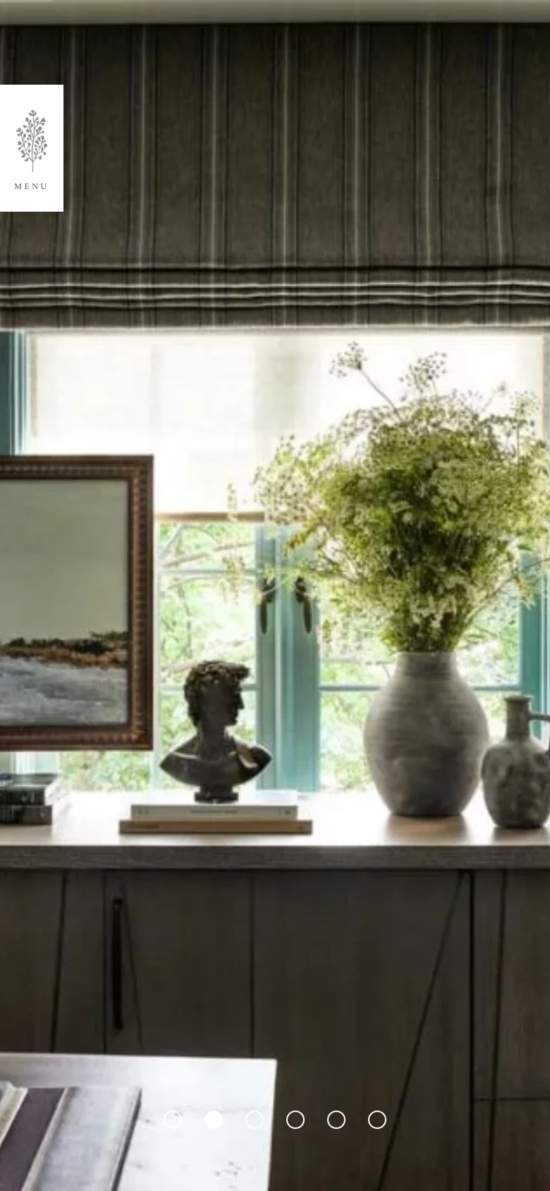 The mobile version transitions to a full-width hero image of the interior scene, with the navigation menu hidden behind a white 'MENU' button featuring a botanical icon. The layout is vertically oriented, prioritizing the large lifestyle photography over the text-based navigation seen on desktop.