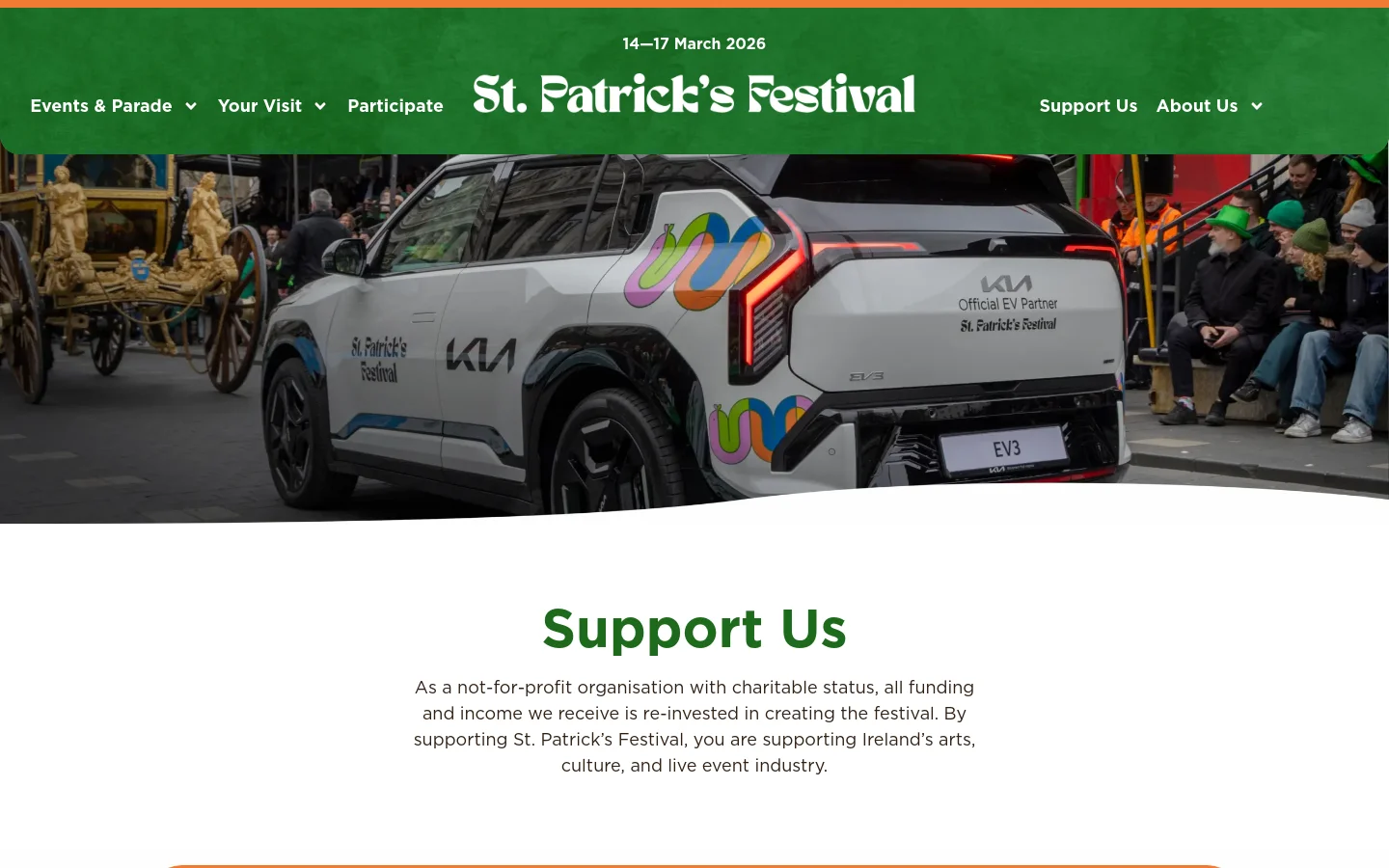 The desktop page features a green header with the St. Patrick's Festival logo and navigation links. A large hero image shows a white Kia EV3 car with festival branding alongside a gold parade float, followed by a white section with the large green headline 'Support Us' and introductory text. The layout uses wide sections with high-quality parade photography interspersed with text about sponsorship, funders, and donations.