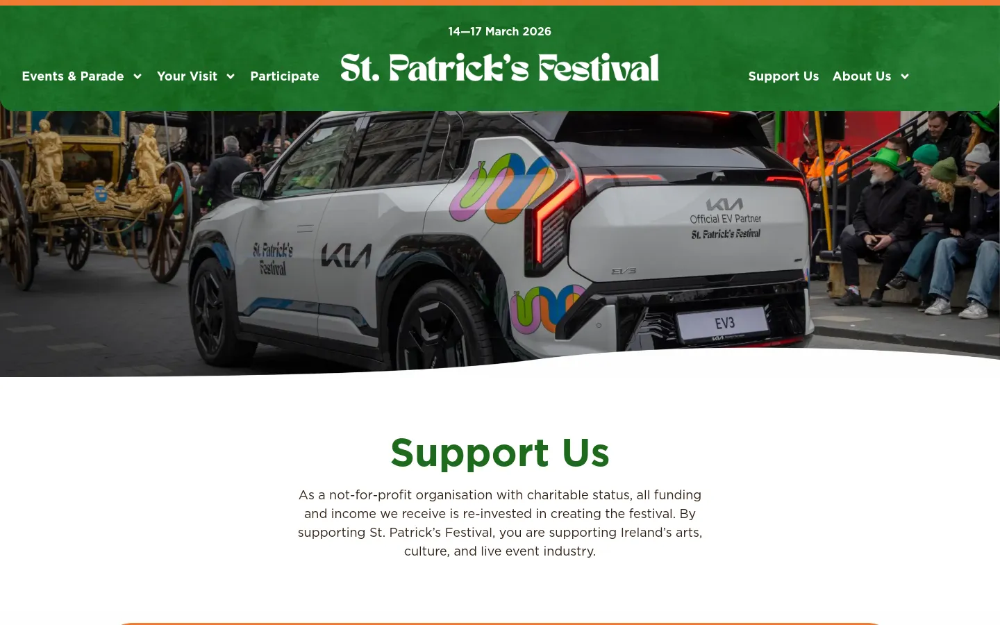 The desktop page features a green header with the St. Patrick's Festival logo and navigation links. A large hero image shows a white Kia EV3 car with festival branding alongside a gold parade float, followed by a white section with the large green headline 'Support Us' and introductory text. The layout uses wide sections with high-quality parade photography interspersed with text about sponsorship, funders, and donations.