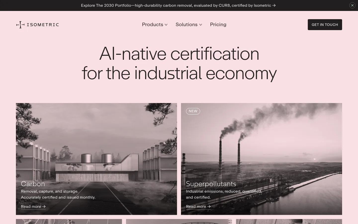 The desktop homepage features a minimalist design with a light pink background and large, centered black text reading 'AI-native certification for the industrial economy.' Below the headline, two large side-by-side photographic tiles show industrial landscapes in grayscale; the left tile is for 'Carbon' and the right for 'Superpollutants,' both including 'Read more' links. A top navigation bar includes the Isometric logo, dropdown menus for Products and Solutions, Pricing, and a 'Get In Touch' button.