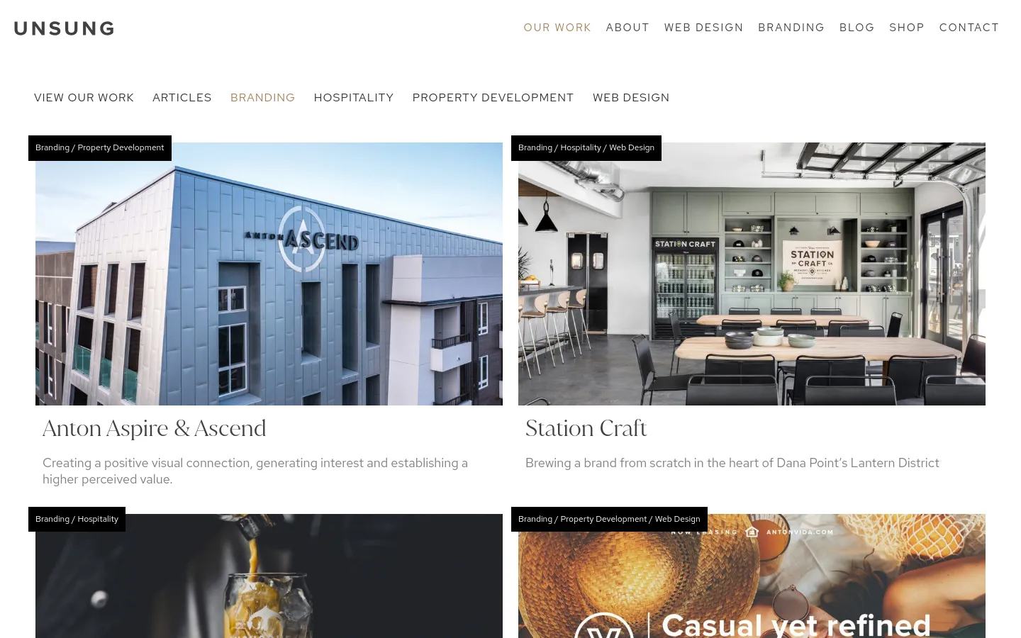 The 'Our Work' page features a clean, minimalist layout with a white background and dark text. A horizontal navigation menu categorizes projects into Branding, Hospitality, Property Development, and Web Design. Below the menu, a grid of large, high-quality project images is displayed, each accompanied by a black category tag, a bold title, and a brief descriptive paragraph.