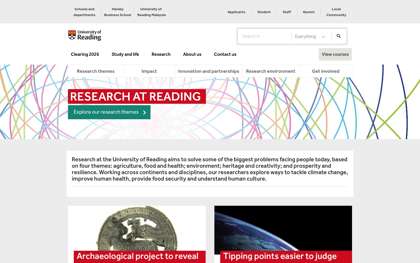 The desktop page features a white header with the University of Reading logo and a navigation menu. A large hero section displays a colorful abstract pattern of intersecting lines with the headline 'RESEARCH AT READING' and a teal 'Explore our research themes' button. Below, a text block describes the university's four research themes against a light grey background.