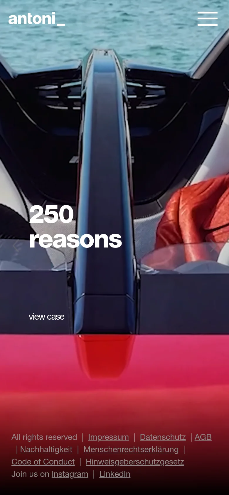 The mobile version presents a vertically oriented view of the same hero image, focusing on the interior of the red car and the large '250 reasons' headline. The navigation menu is condensed into a hamburger icon at the top right, and the footer links are stacked at the bottom.