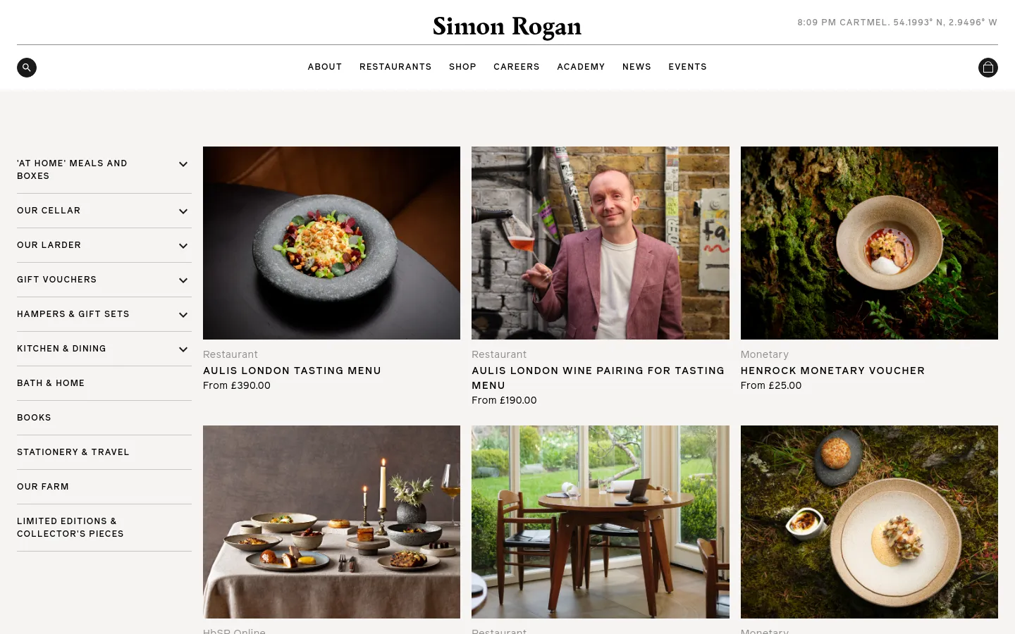 The desktop page features a minimalist white background with the Simon Rogan logo at the top center. A grid of large, high-quality food and lifestyle images displays various gift options like the Aulis London Tasting Menu and Henrock Monetary Voucher, accompanied by category labels and prices. A left-hand sidebar provides navigation links to different product categories such as Our Cellar, Our Larder, and Gift Vouchers.