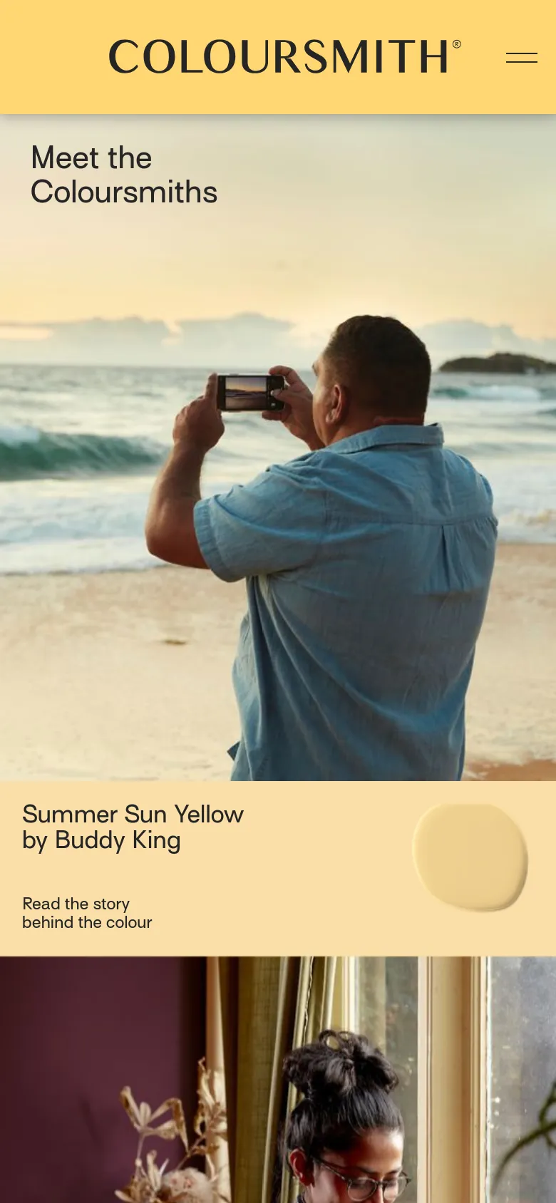 The mobile version maintains the yellow header and the hero image of a man photographing the ocean, but the headline 'Meet the Coloursmiths' is positioned more centrally. The content shifts to a single-column vertical stack where color stories like 'Summer Sun Yellow' appear with large color swatches and text below the hero image.