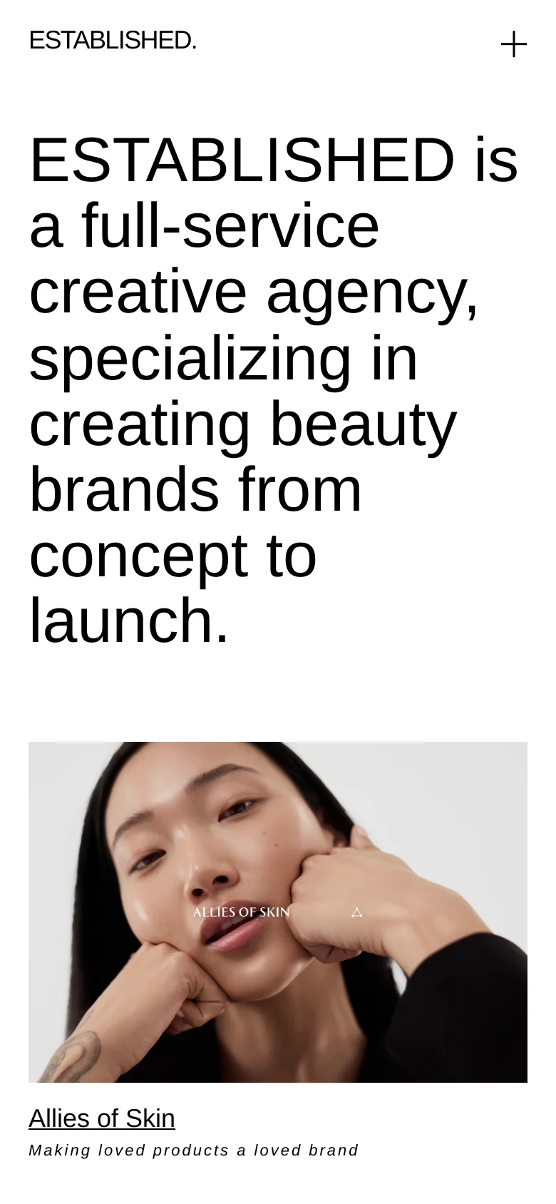 The mobile version maintains the minimalist aesthetic with a single-column layout. The large headline dominates the top of the screen, followed by a vertically stacked list of large project images and descriptions. The navigation is simplified, using a plus icon in the top right to open the menu, ensuring a clean and focused browsing experience on smaller screens.