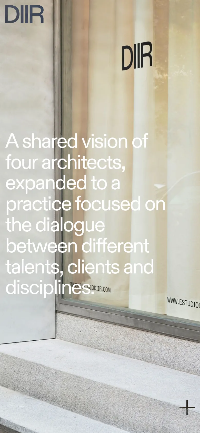 The mobile version maintains the minimalist aesthetic but presents the content in a vertical orientation. The background image of the building entrance is cropped to focus on the glass and stone textures, and the large white text is stacked vertically to fit the narrower screen width.