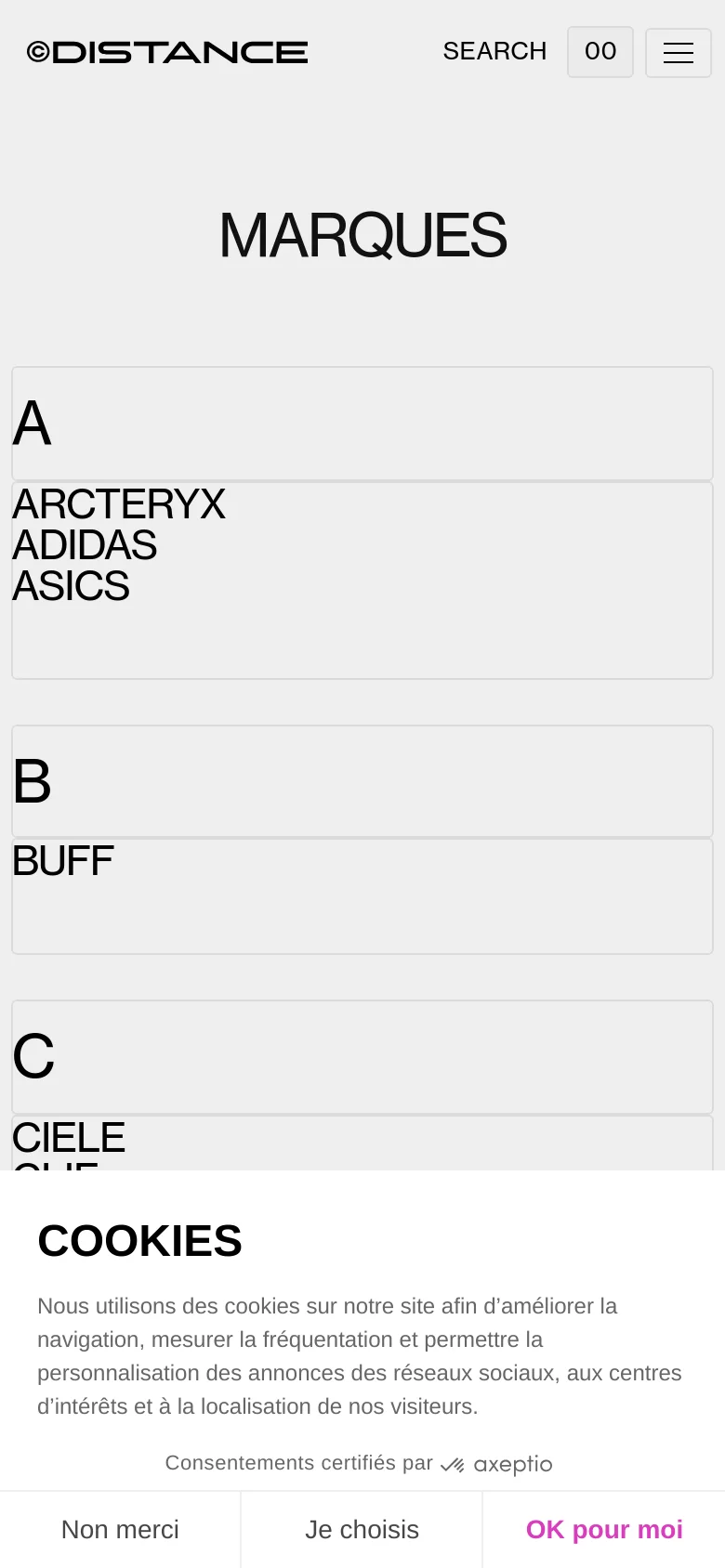 The mobile version maintains the minimalist white and grey aesthetic but uses a single-column vertical layout for the brand list. The header is condensed with a hamburger menu icon and a search option, while the large 'MARQUES' title remains centered above the alphabetical brand groupings.