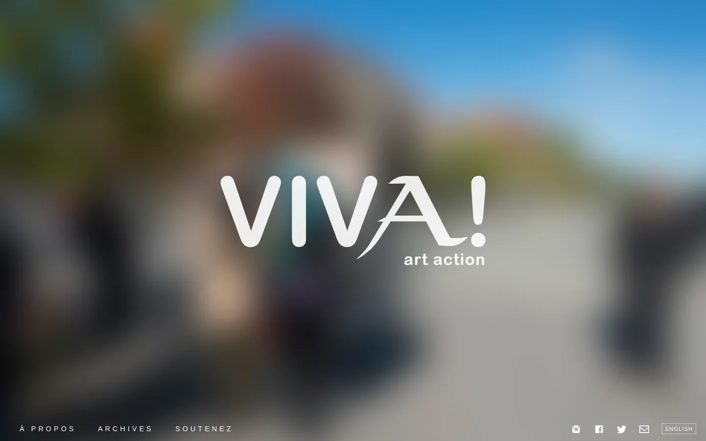 The desktop homepage features a large, blurred background image of an outdoor scene with the white text 'VIVA! art action' centered in the middle. A minimalist navigation bar at the bottom includes links for 'À PROPOS', 'ARCHIVES', and 'SOUTENEZ', alongside social media icons and an 'ENGLISH' language selector.