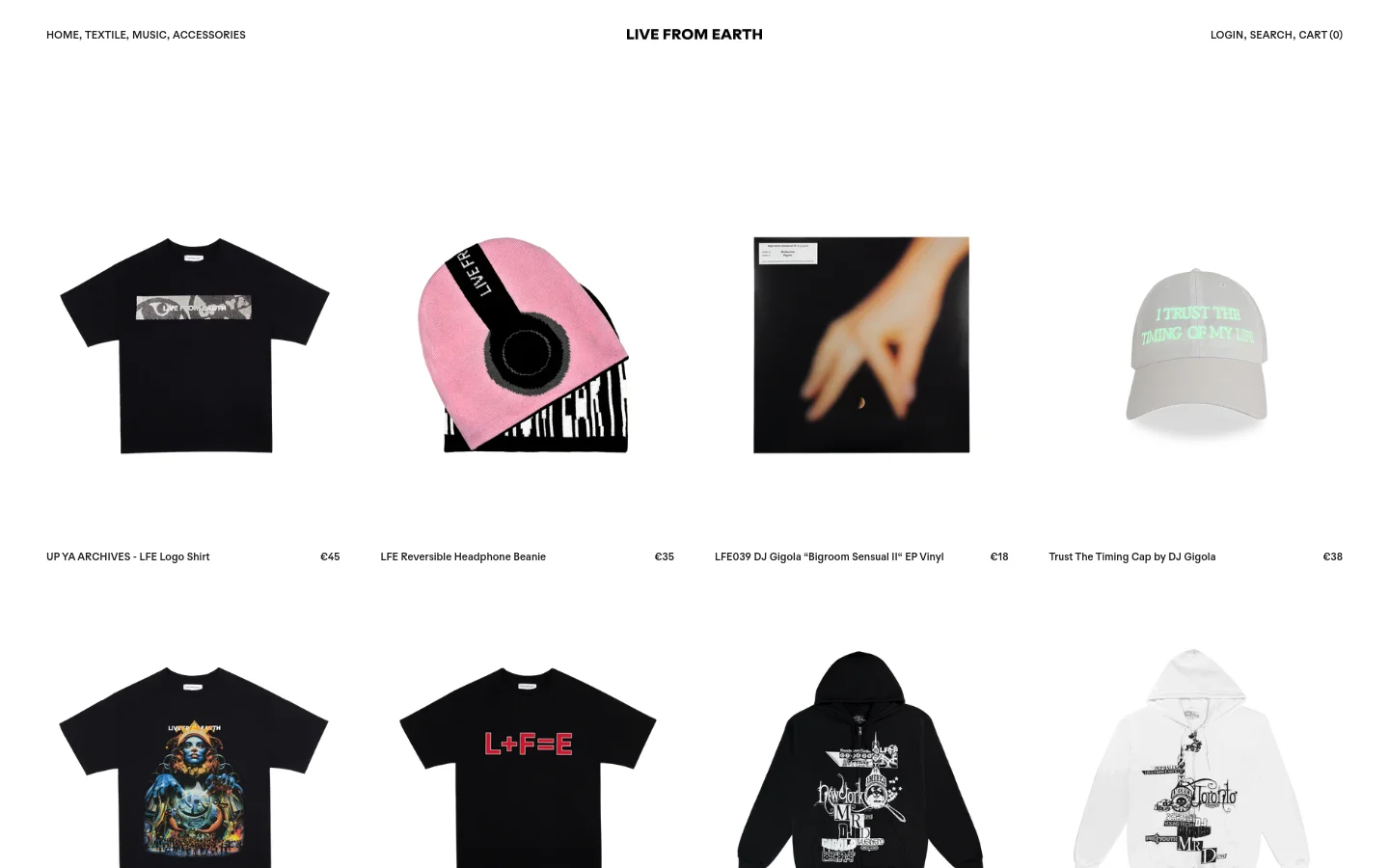 The desktop homepage for LIVE FROM EARTH features a minimalist white background with a clean navigation bar at the top. A grid layout displays various products including logo t-shirts, a pink reversible beanie, vinyl records, and a white cap, each accompanied by its name and price in black text. The layout is spacious with large product images arranged in rows.