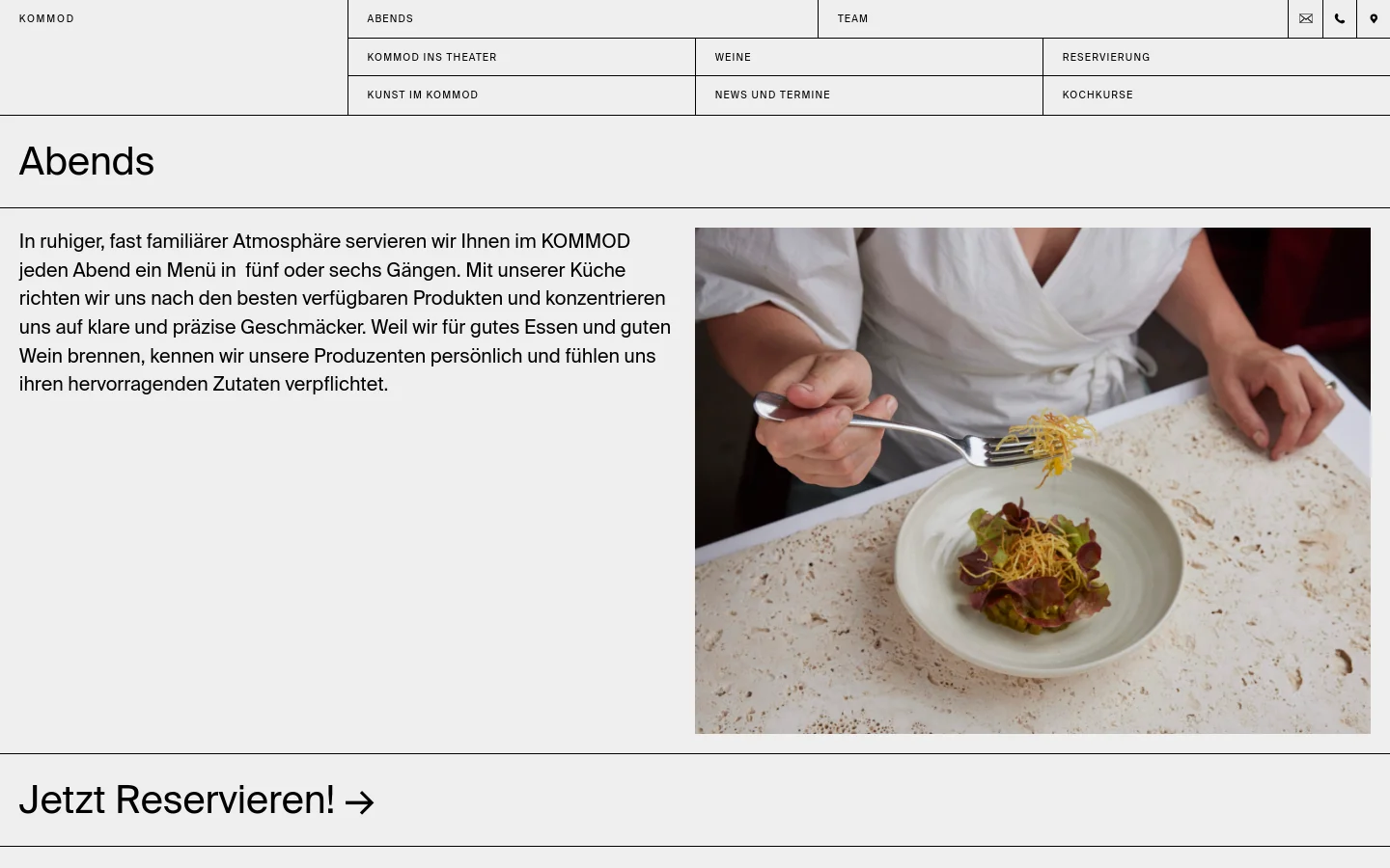 The desktop page features a minimalist design with a white background and black text. A large hero image on the right shows a chef plating a salad, while the left side contains an introductory text about evening menus and a prominent 'Jetzt Reservieren!' call to action. The navigation menu is spread across a wide grid at the top of the page.