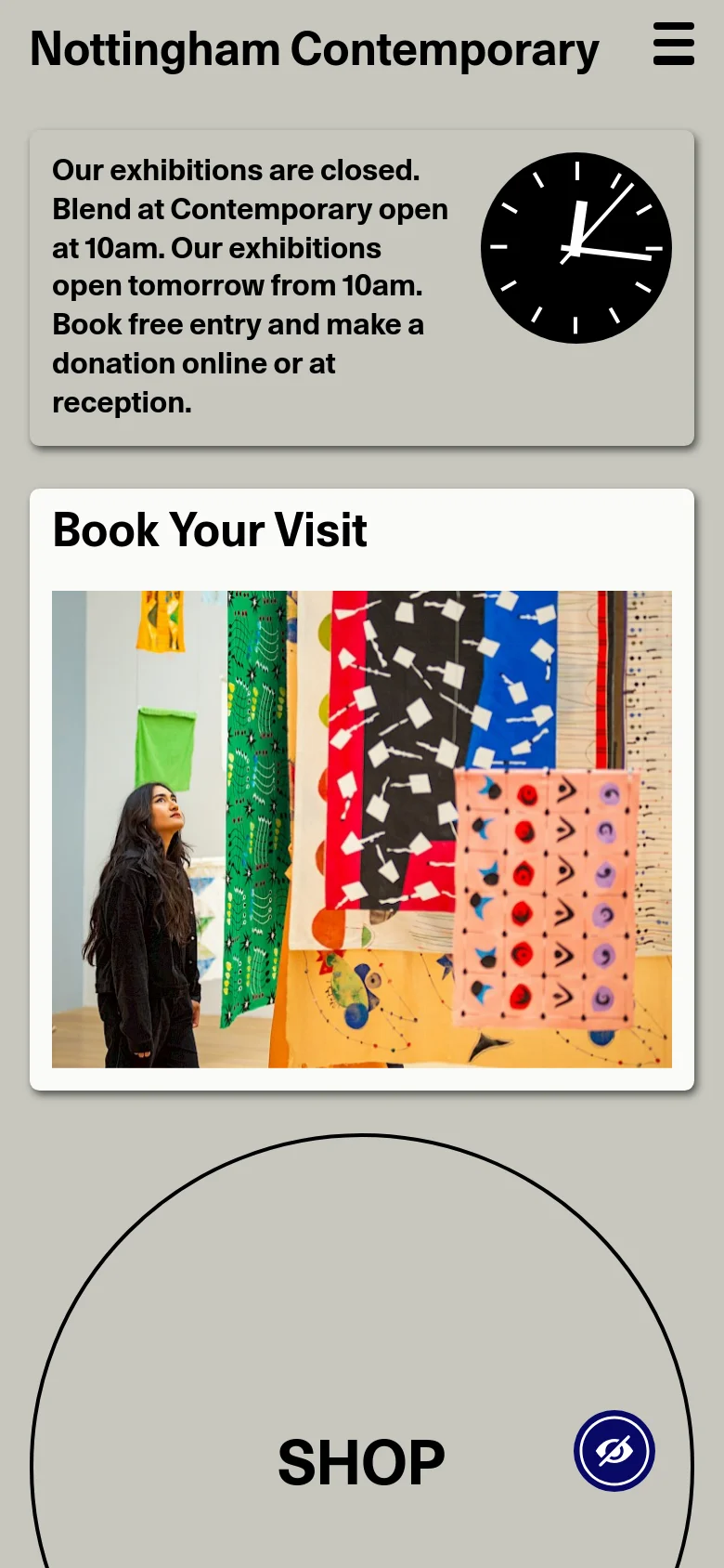 The mobile version uses a simplified vertical layout with a hamburger menu icon for navigation. The top status banner and 'Book Your Visit' section are stacked vertically, and the large circular 'Shop' button is centered prominently below the hero image, prioritizing ease of scrolling on a smaller screen.