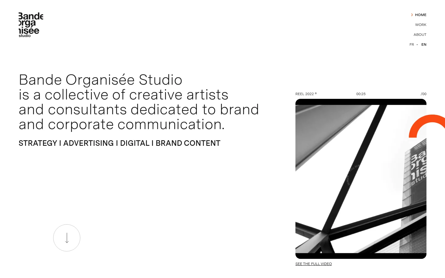 The desktop homepage features a minimalist white layout with a large headline on the left describing the creative studio. To the right, a video player displays a black and white architectural reel with a play button and a link to see the full video. A navigation menu is located in the top right corner, and a downward arrow icon sits at the bottom left.