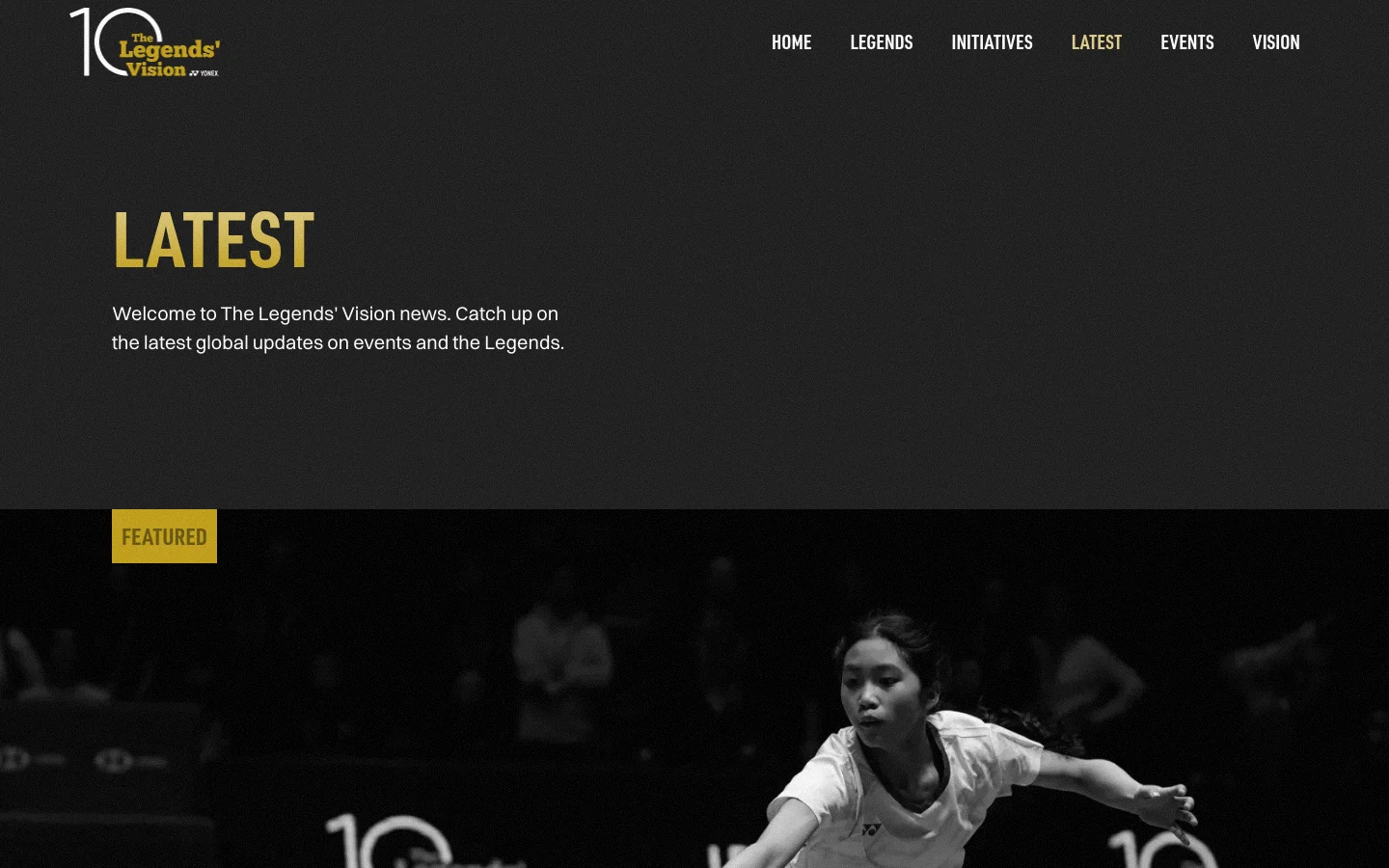 The desktop page features a dark theme with gold accents and a large 'LATEST' headline. Below the introductory text, a 'FEATURED' section displays a large, black-and-white hero image of a badminton player, followed by a grid of news articles with images, dates, and titles.