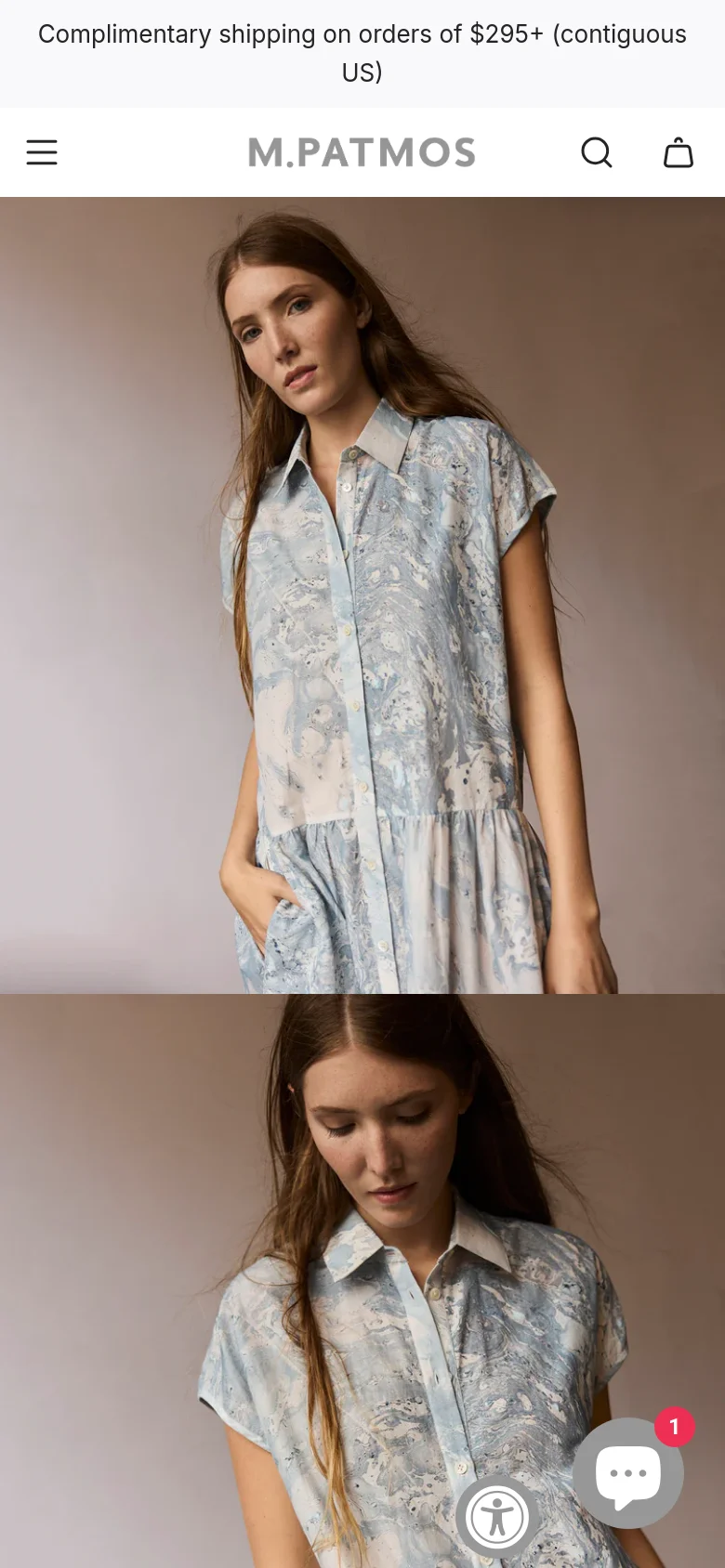 The mobile version maintains the minimalist aesthetic but uses a condensed header with a hamburger menu, search icon, and shopping bag icon. The hero image of the woman in the blue patterned dress is stacked vertically to fit the narrow screen. A floating chat icon and an accessibility icon appear in the bottom right corner.
